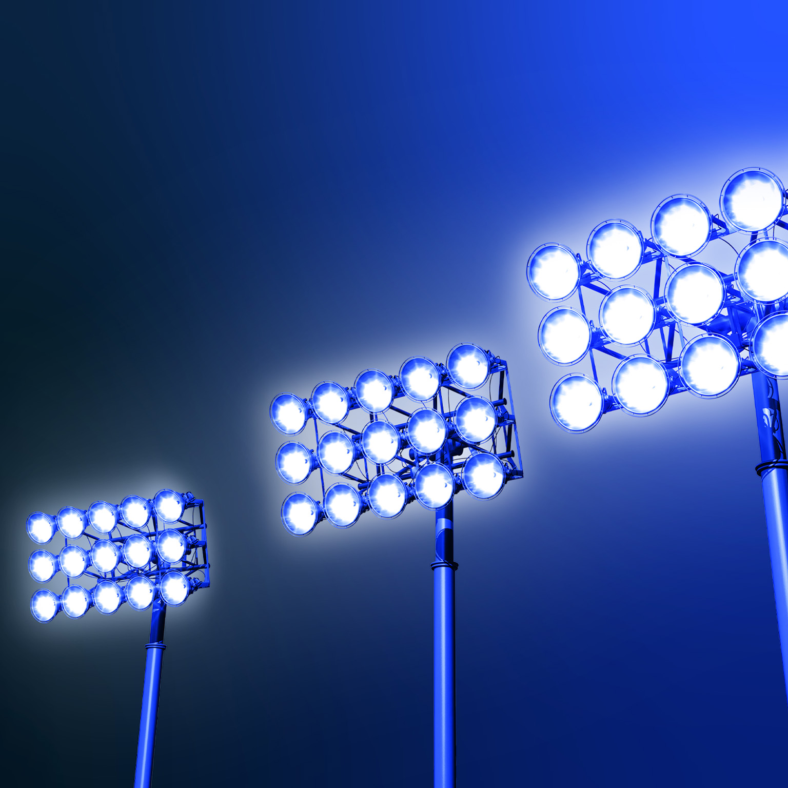 Against a dark blue backdrop, three sets of stadium lights emit a radiant glow, evoking a feeling of excitement and suspense.