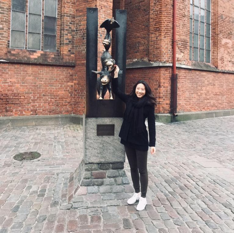 Jo on street touching statue